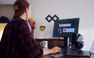 Web designer at a desk reviewing client feedback on a website