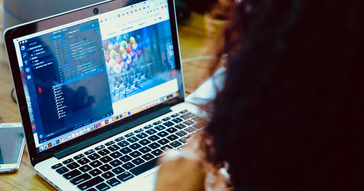 Team at a computer reviewing issues in a free bug tracking tool