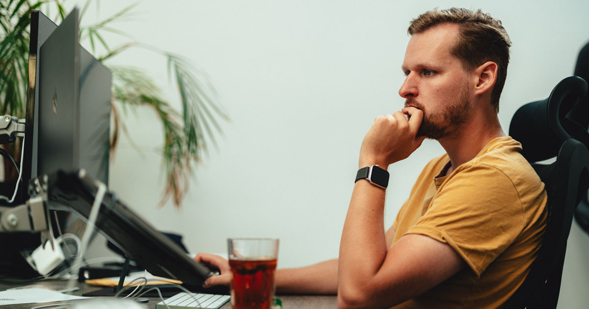 Client doing user acceptance testing on a new website at his desk